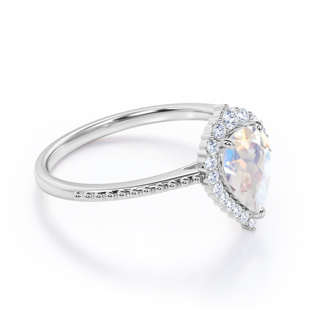 Royal themed 1.3 carat Pear Moonstone and diamond Milgrain and halo engagement ring in White gold