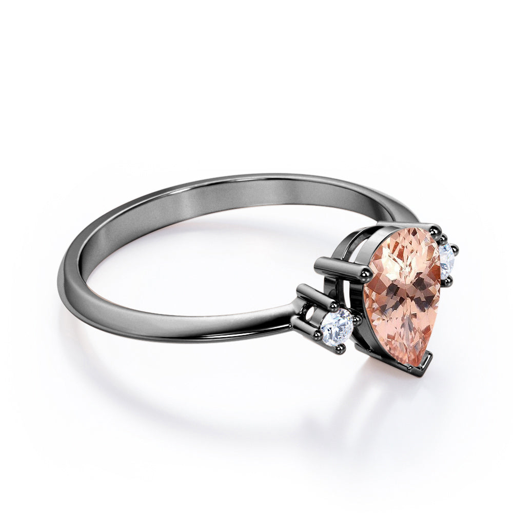 Three prong setting 1.1 carat Pear shaped Morganite and diamond trilogy anniversary ring for women in Black gold