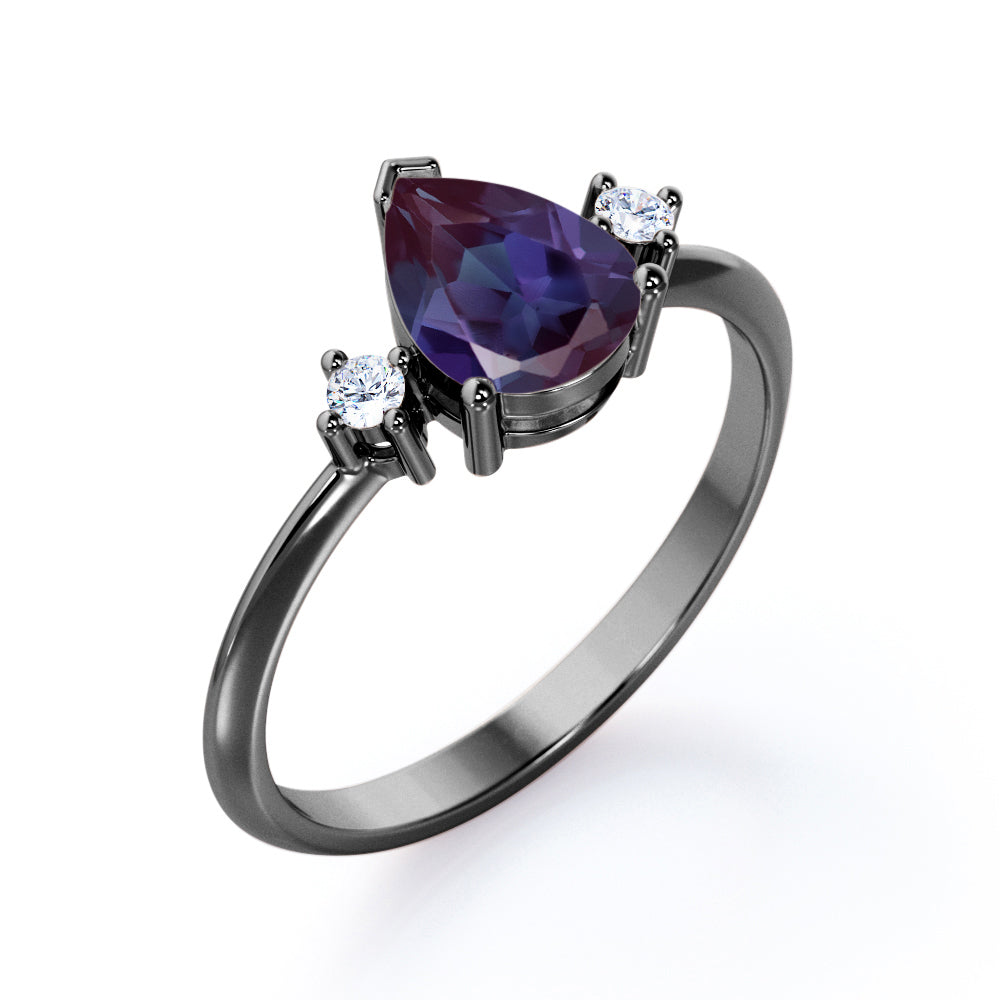 Classic three stone 1.1 carat Pear shaped Alexandrite and diamond pinched shank engagement ring for women in Black gold