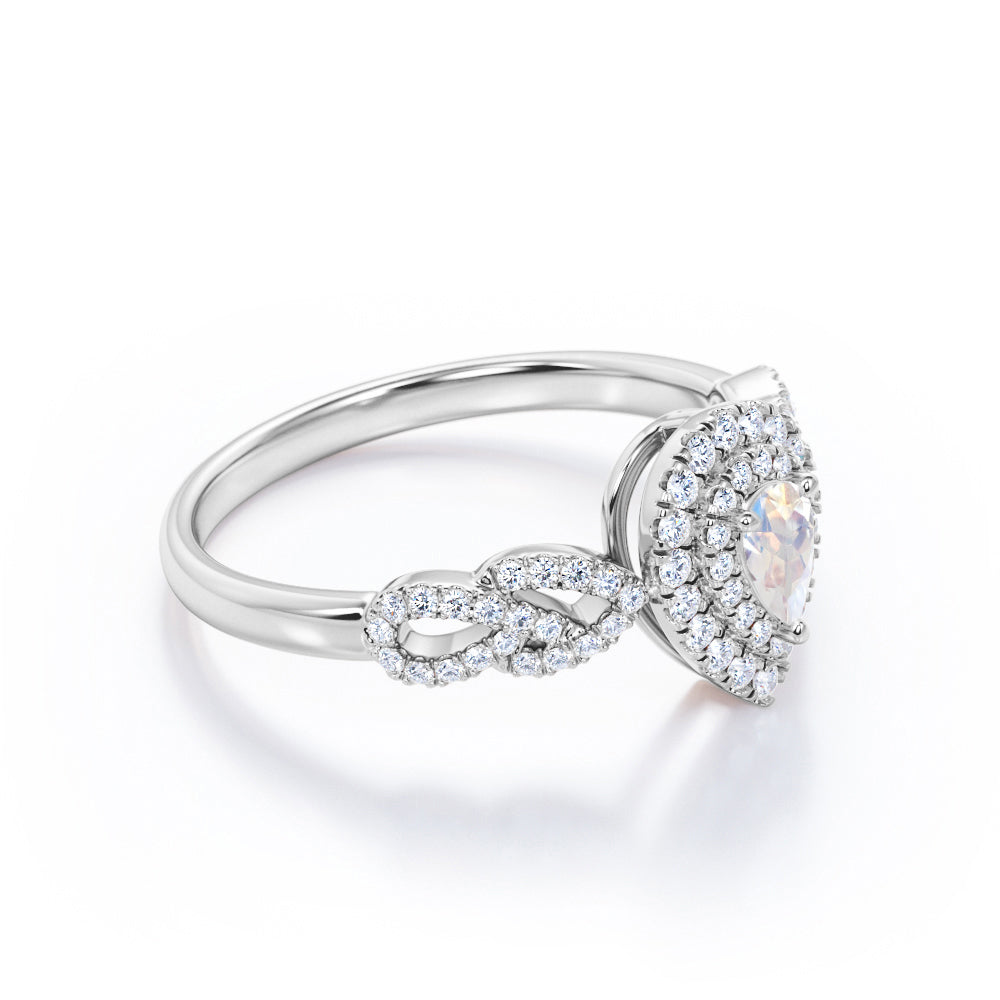 Intertwined 1.7 carat Pear shaped Blue Moonstone and diamond twisted infinity halo engagement ring in White gold