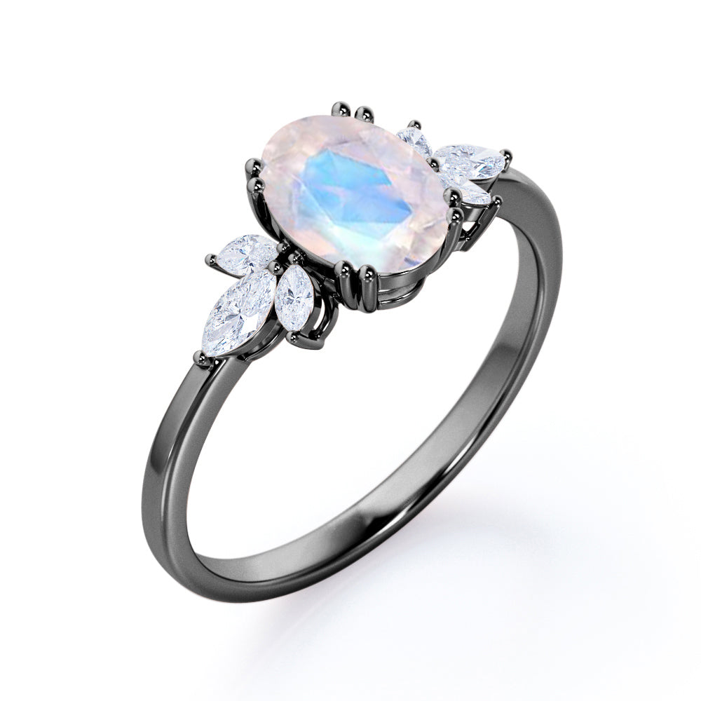 Floral inspired 1.25 carat Oval cut Rainbow Moonstone and marquise diamond double prong engagement ring in Black gold