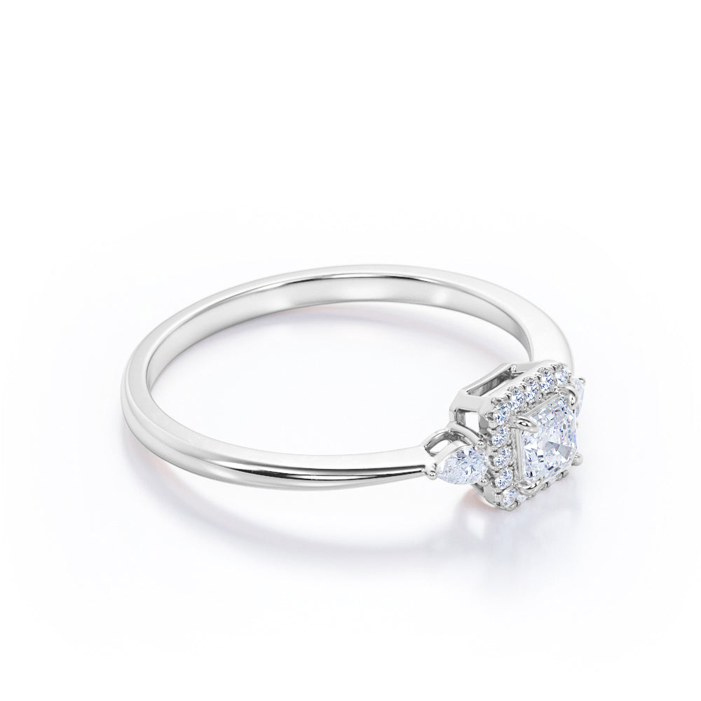 Tapered triple stone 0.7 carat Round cut Moissanite and diamond halo engagement ring in White gold