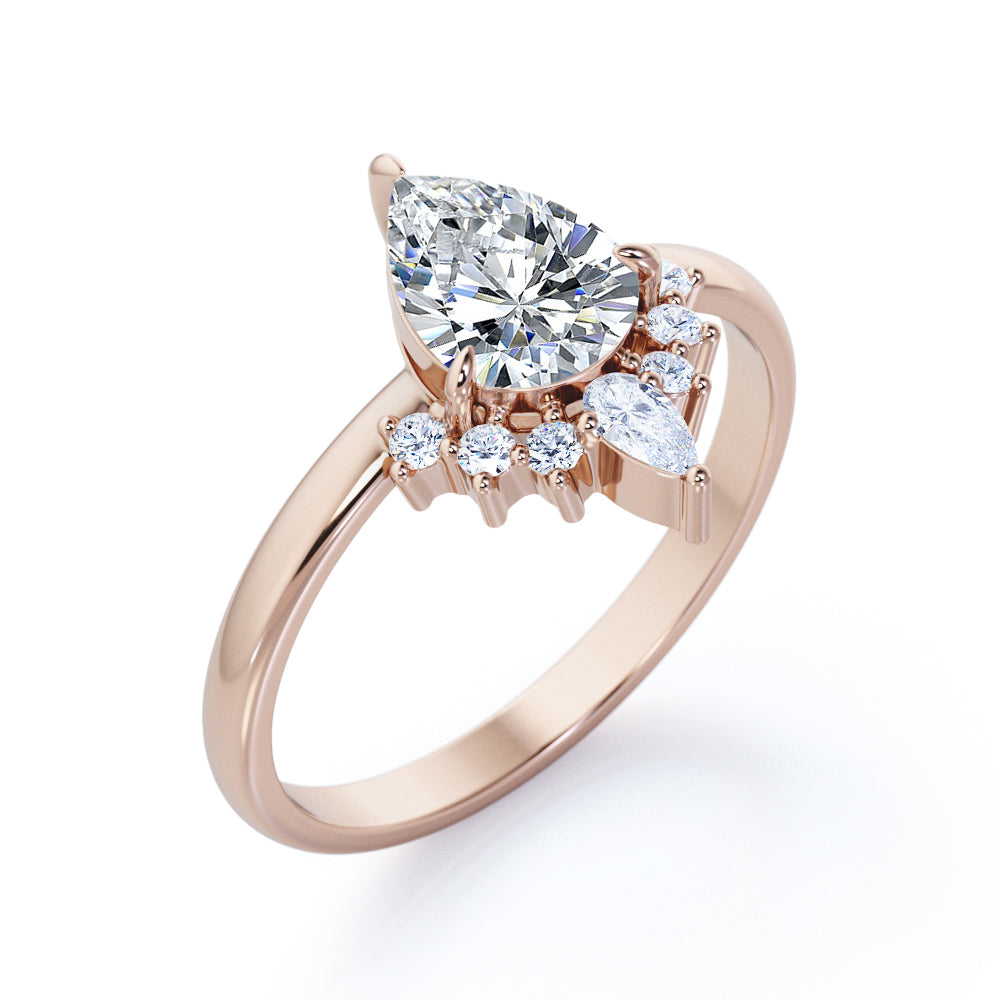 Chevron crown inspired 1.1 carat Pear shaped Moissanite and diamond engagement ring in Rose gold