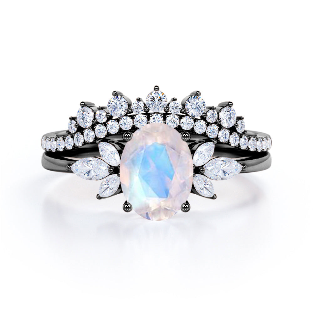 Garland Inspired 1.65 carat Oval shaped Blue Moonstone and diamond contoured seven stone Bridal set in Black gold