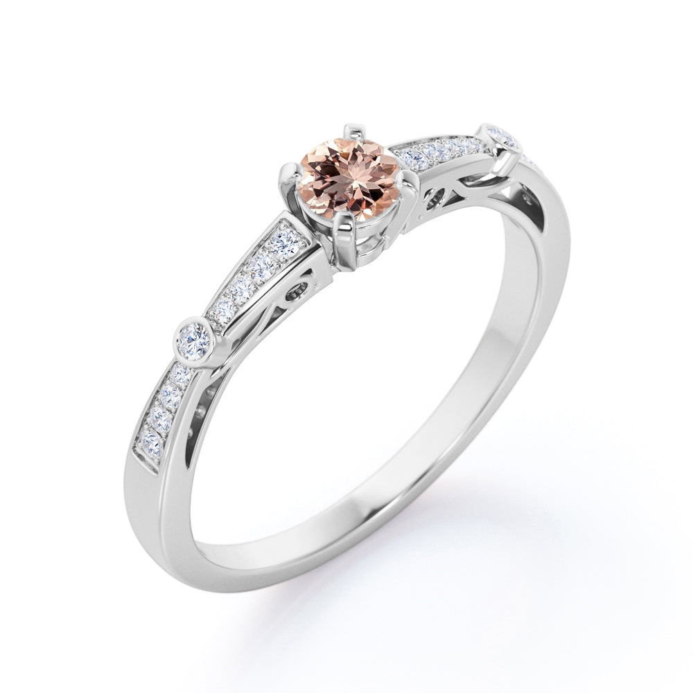 Prong style 0.75 carat Round cut Peach Pink Morganite and diamond tapered baguette engagement ring in White gold