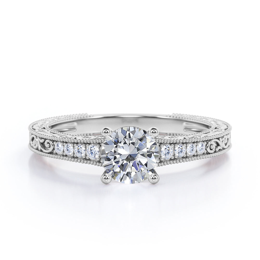 Artistic filigree 1.1 carat Moissanite and diamond low-basket setting engagement ring in White gold