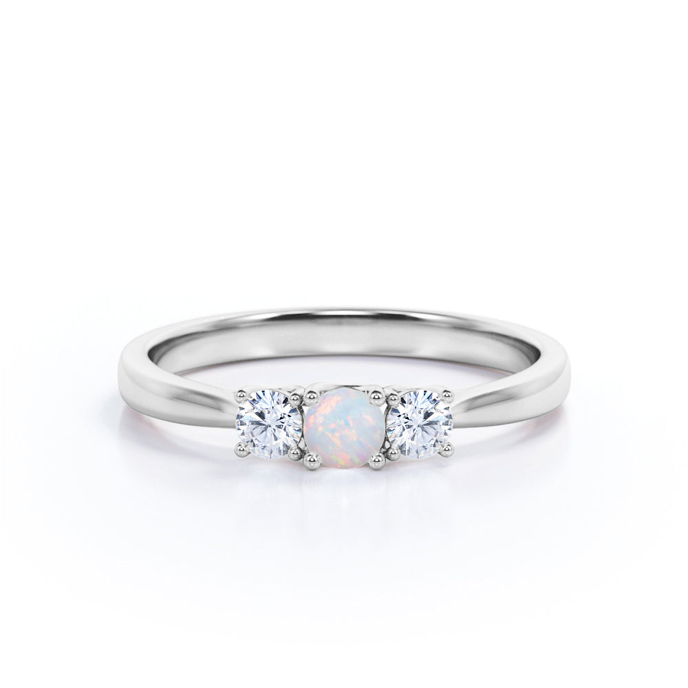 Tapered Shank 0.7 carat Round cut Ethiopian Opal and diamond triple stone engagement ring in Rose gold