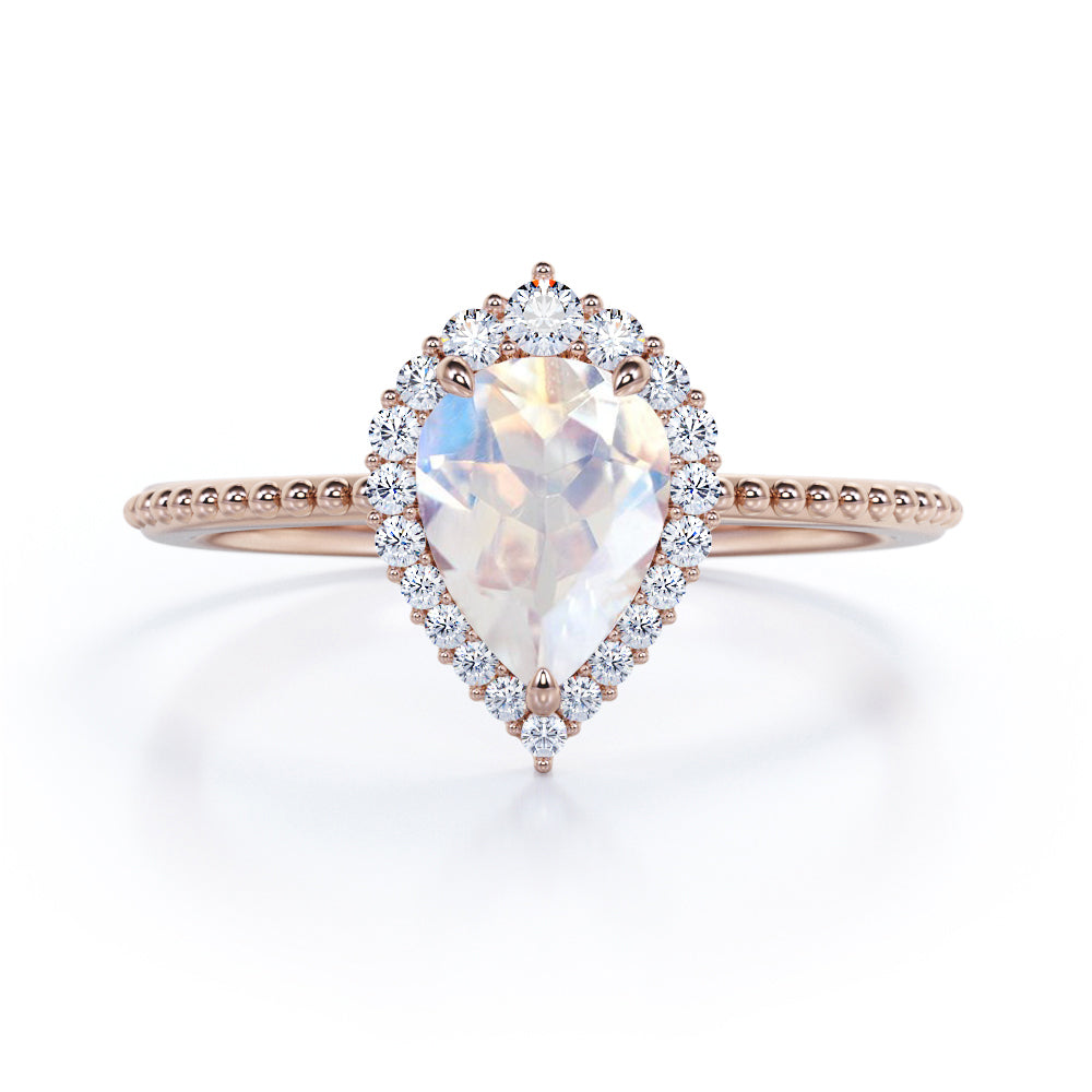 Royal themed 1.3 carat Pear Moonstone and diamond Milgrain and halo engagement ring in White gold