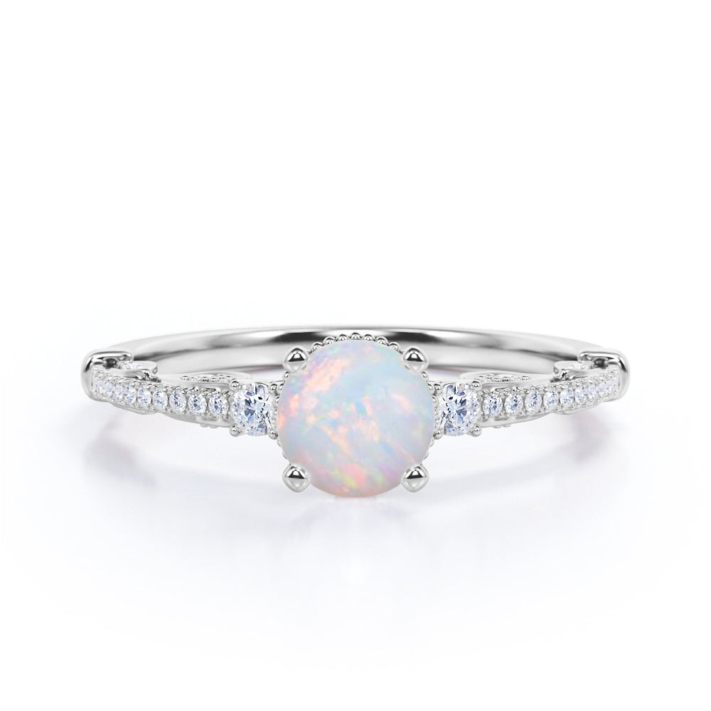 Artistic 3 stone 1.30 carat Round cut Ethiopian Opal and diamond antique art deco engagement ring in Black gold