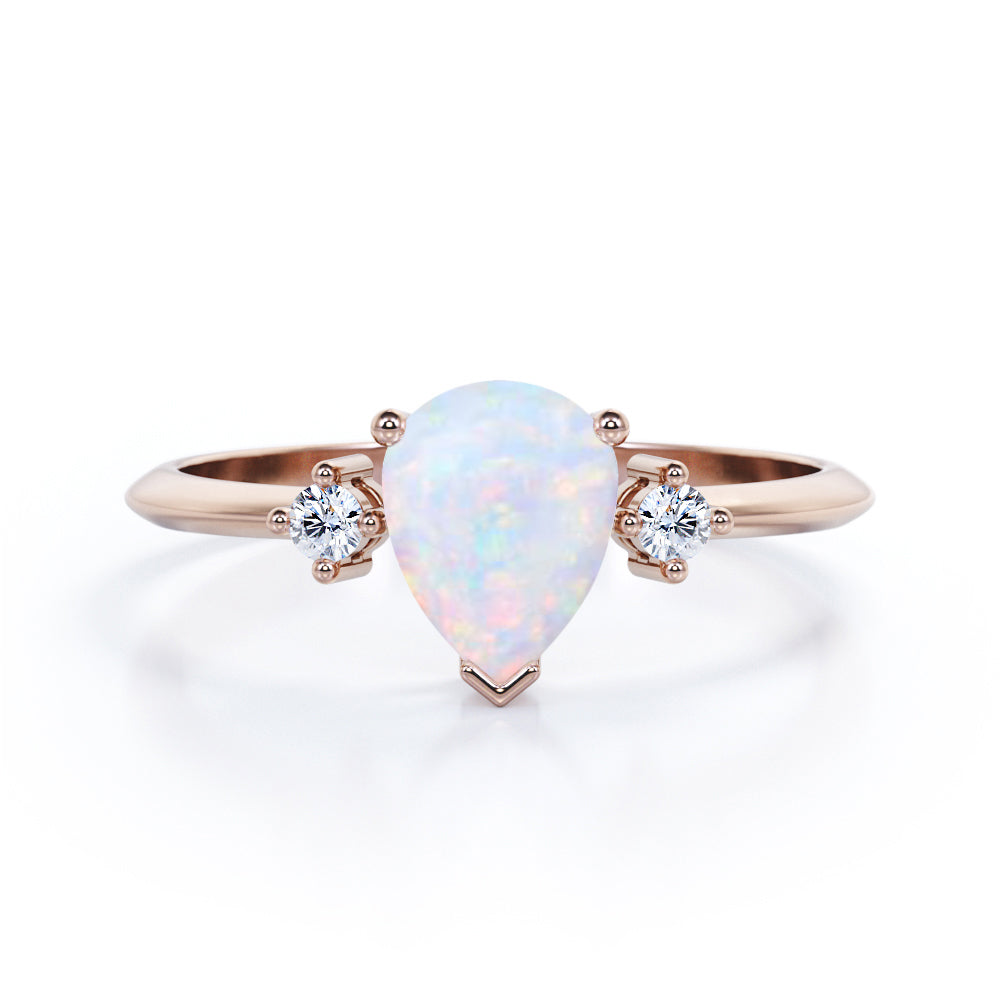 Elegant Three stone 1.10 carat Tear drop shape Ethiopian Opal and diamond pinched shank engagement ring in Black gold