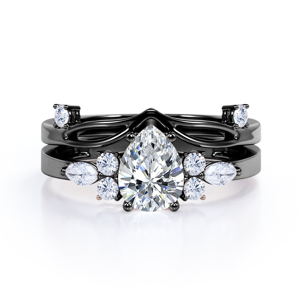 Split shank Chevron 1.2 carat tear drop shaped Moissanite and diamond art deco style engagement ring in Black gold