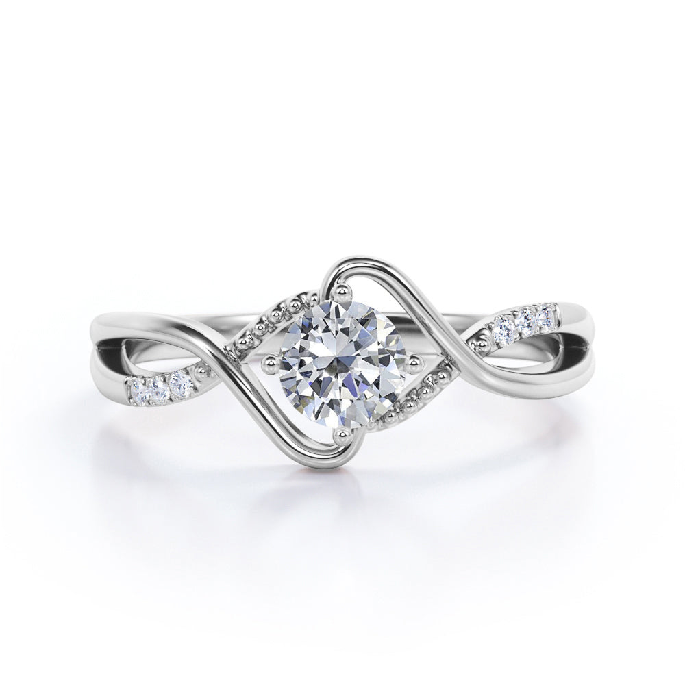 Vintage style twisted 1.25 Round cut Moissanite and diamond infinity engagement ring in Rose gold