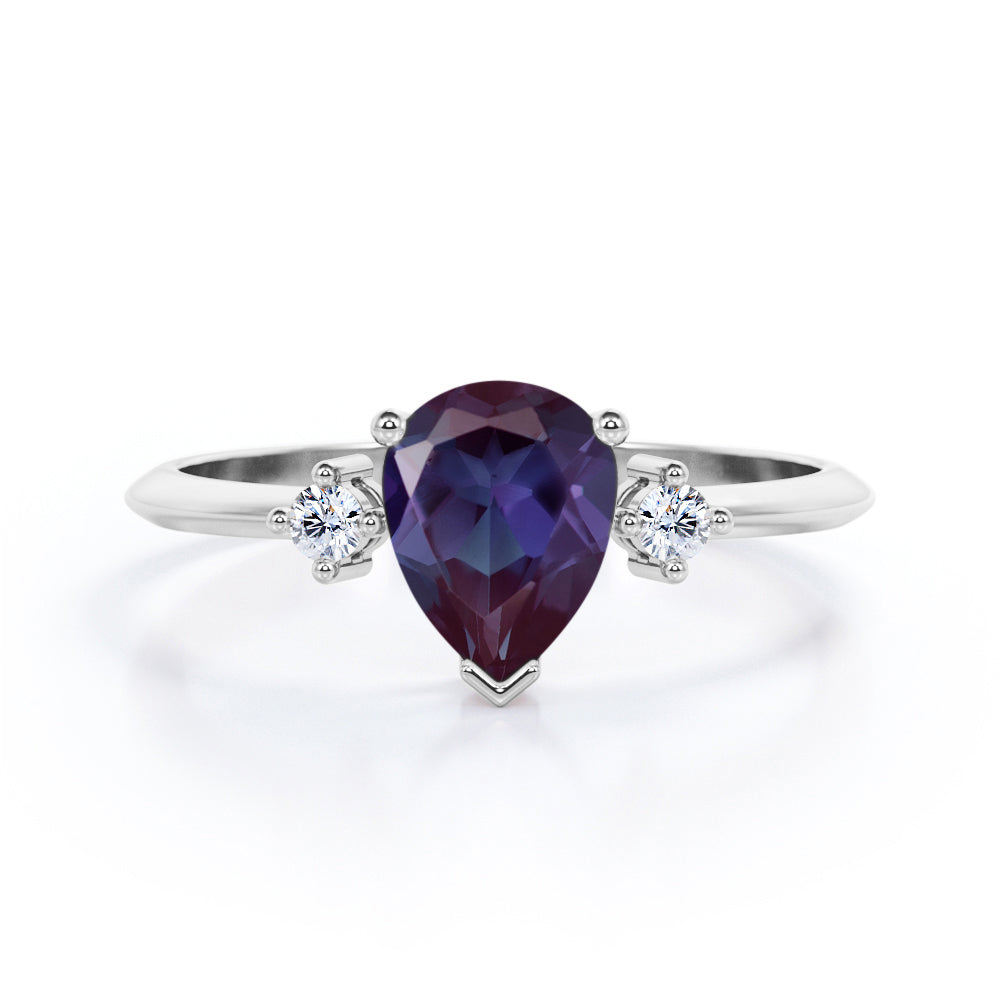 Classic three stone 1.1 carat Pear shaped Alexandrite and diamond pinched shank engagement ring for women in Black gold