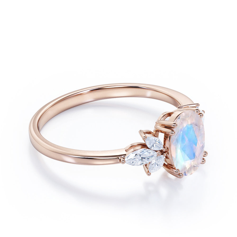 Floral inspired 1.25 carat Oval cut Rainbow Moonstone and marquise diamond double prong engagement ring in Black gold