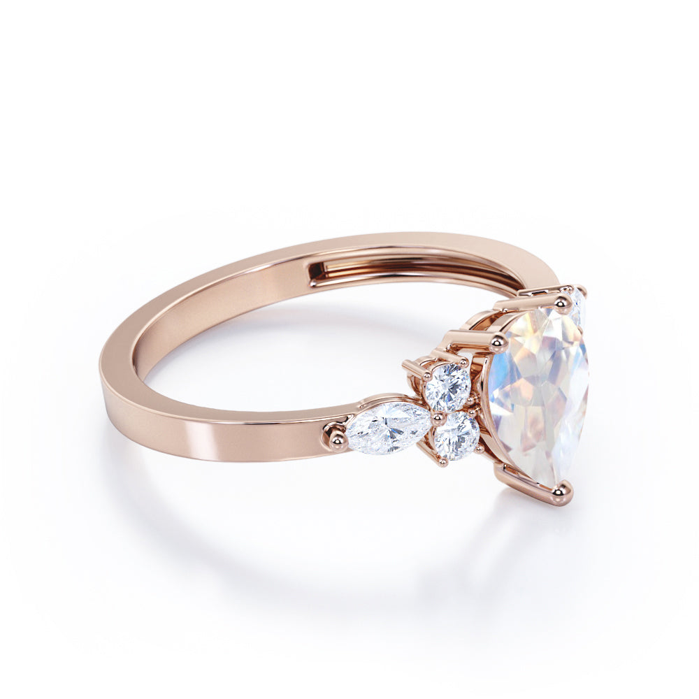 Seven stone 1.25 carat Pear Cut Rainbow Moonstone and diamond triad engagement ring in Black gold