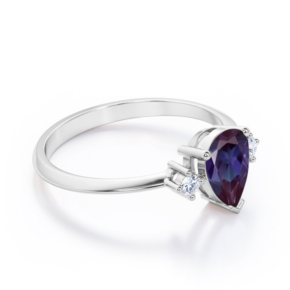 Classic three stone 1.1 carat Pear shaped Alexandrite and diamond pinched shank engagement ring for women in Black gold
