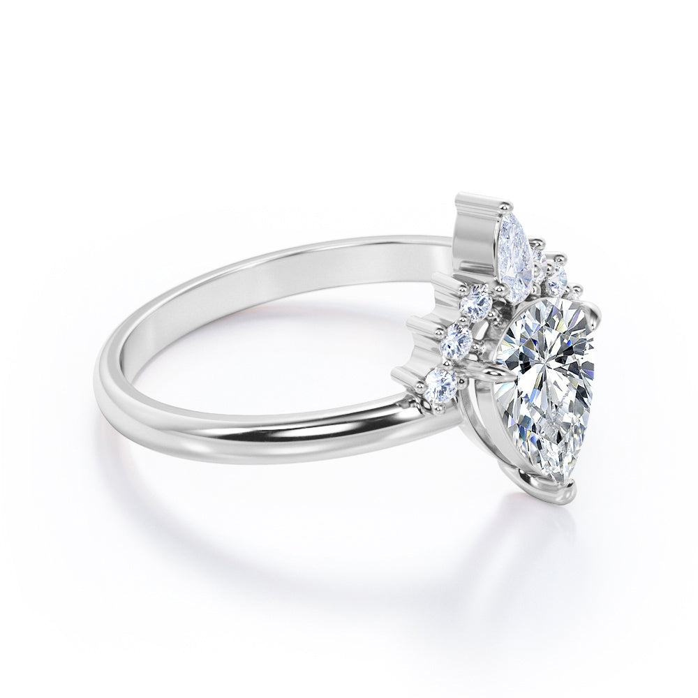 Chevron crown inspired 1.1 carat Pear shaped Moissanite and diamond engagement ring in Rose gold