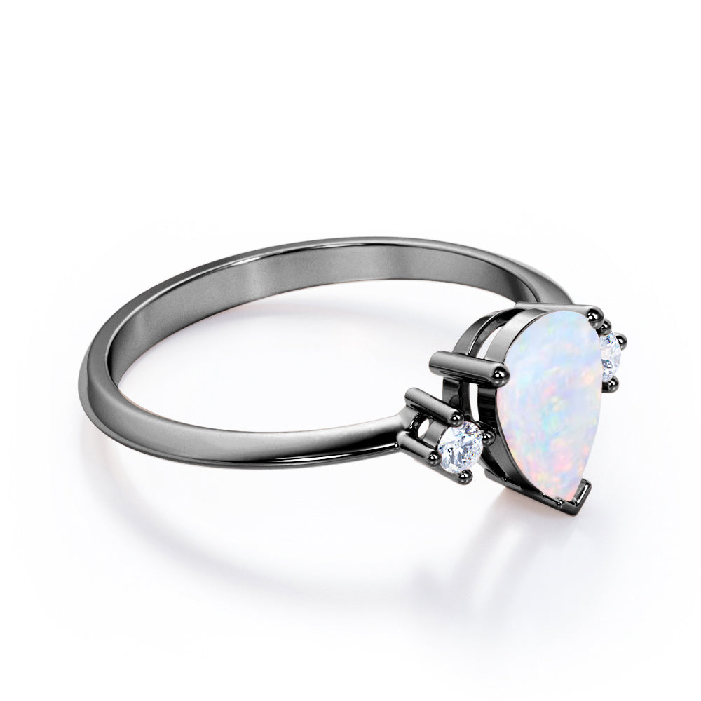 Elegant Three stone 1.10 carat Tear drop shape Ethiopian Opal and diamond pinched shank engagement ring in Black gold