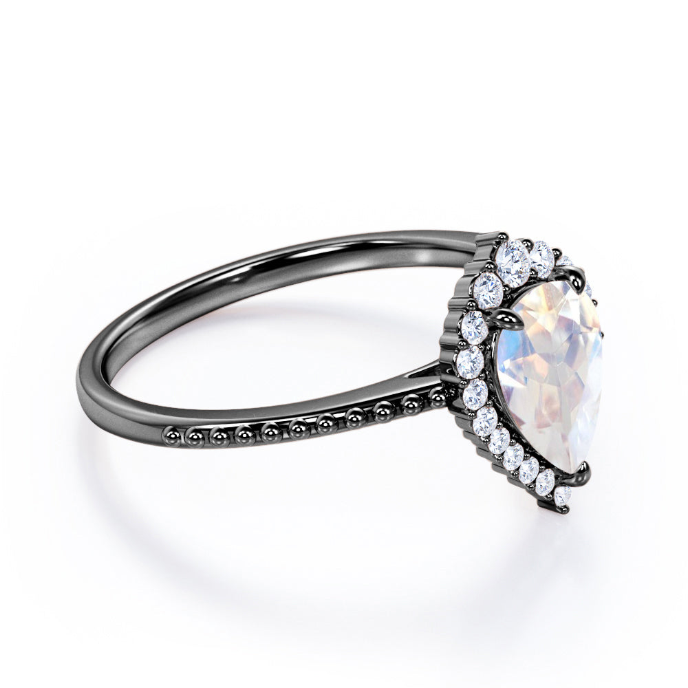 Royal themed 1.3 carat Pear Moonstone and diamond Milgrain and halo engagement ring in White gold