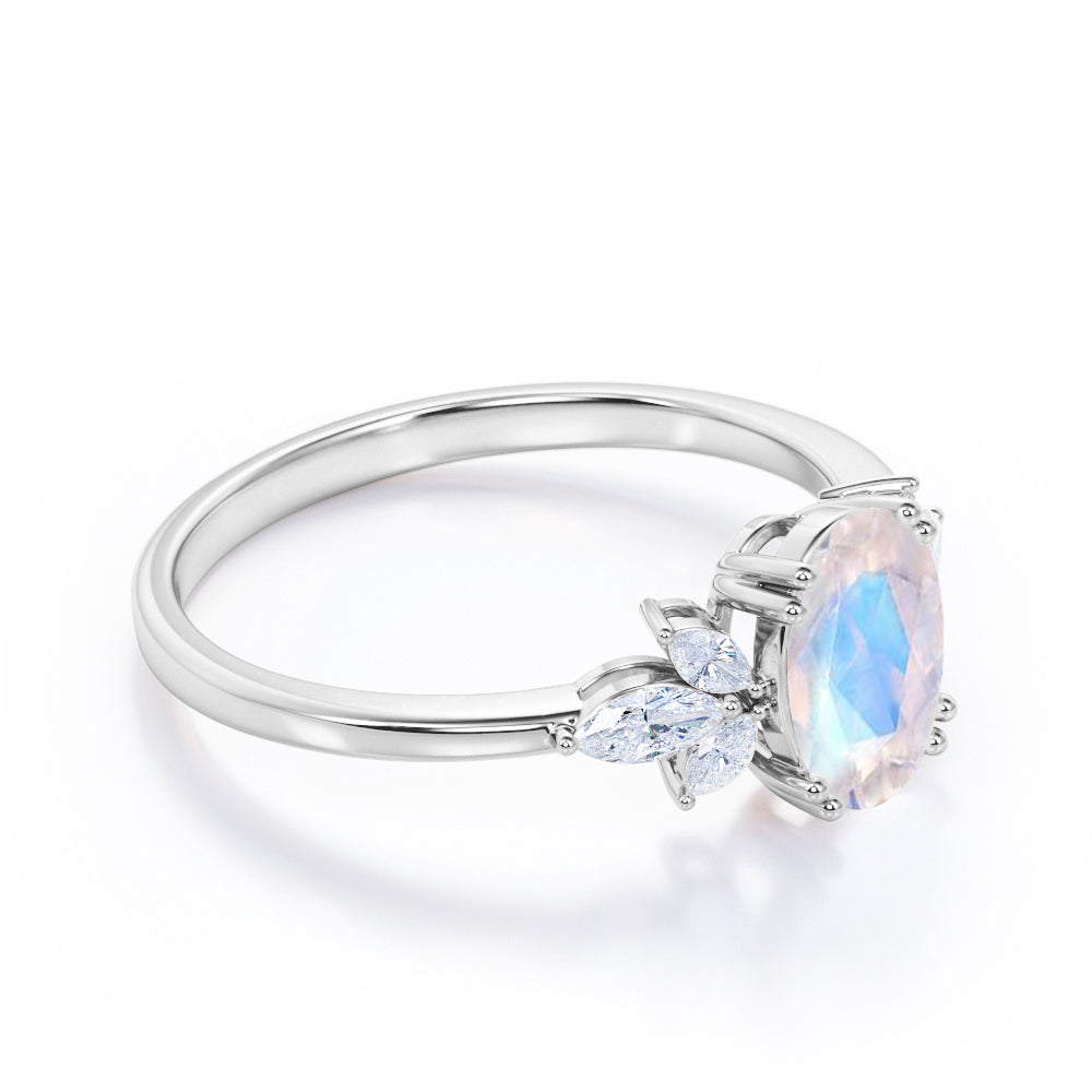 Floral inspired 1.25 carat Oval cut Rainbow Moonstone and marquise diamond double prong engagement ring in Black gold