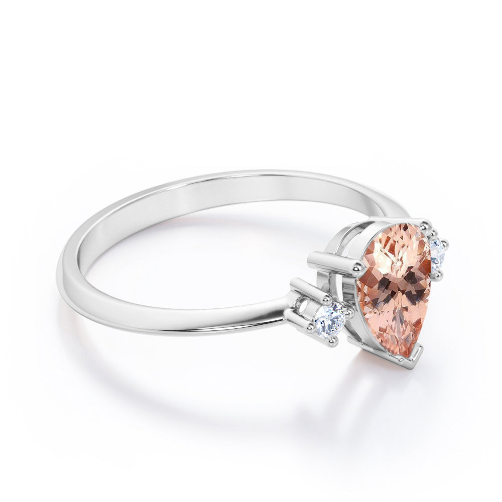 Three prong setting 1.1 carat Pear shaped Morganite and diamond trilogy anniversary ring for women in Black gold
