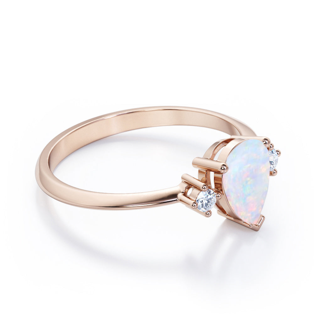Elegant Three stone 1.10 carat Tear drop shape Ethiopian Opal and diamond pinched shank engagement ring in Black gold