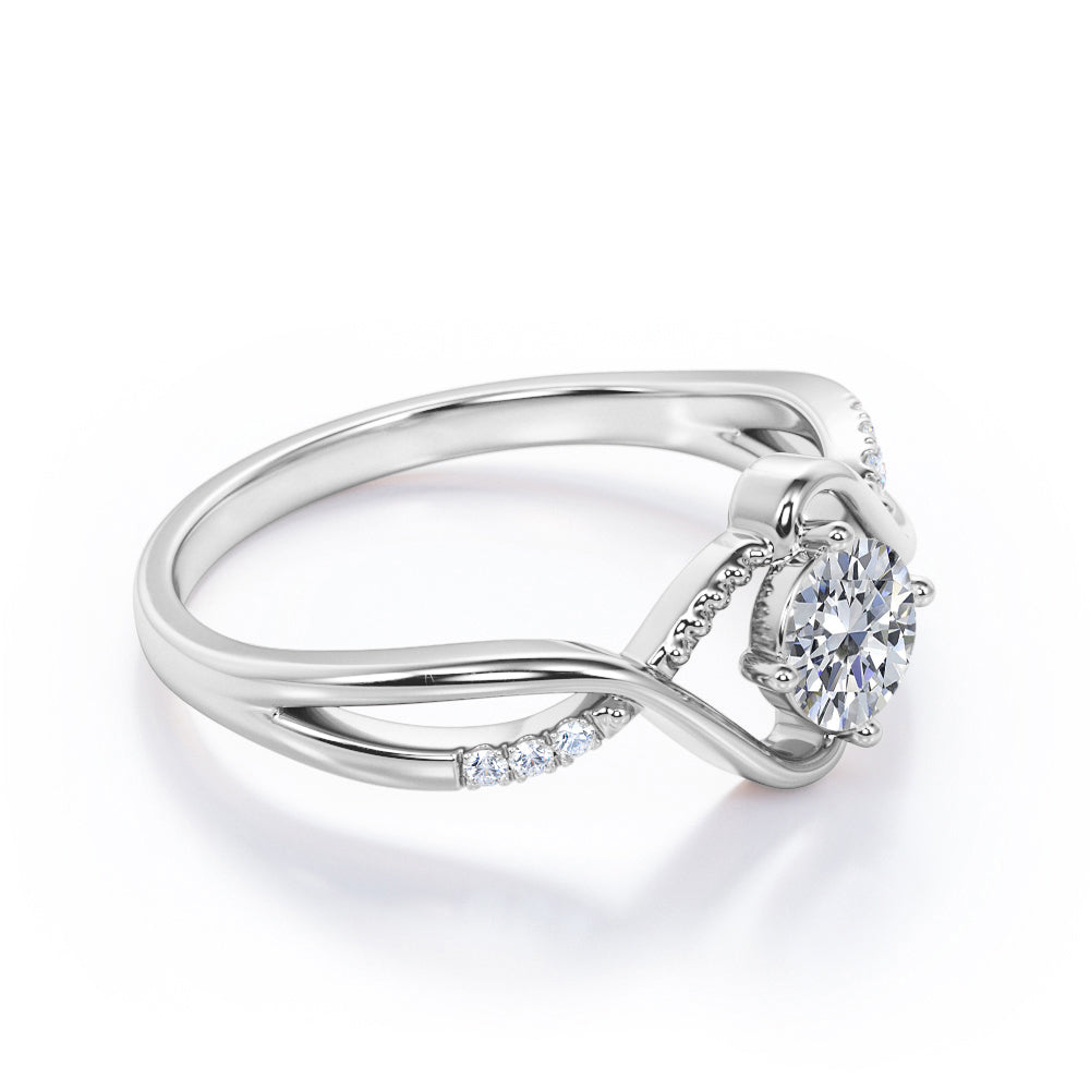Vintage style twisted 1.25 Round cut Moissanite and diamond infinity engagement ring in Rose gold