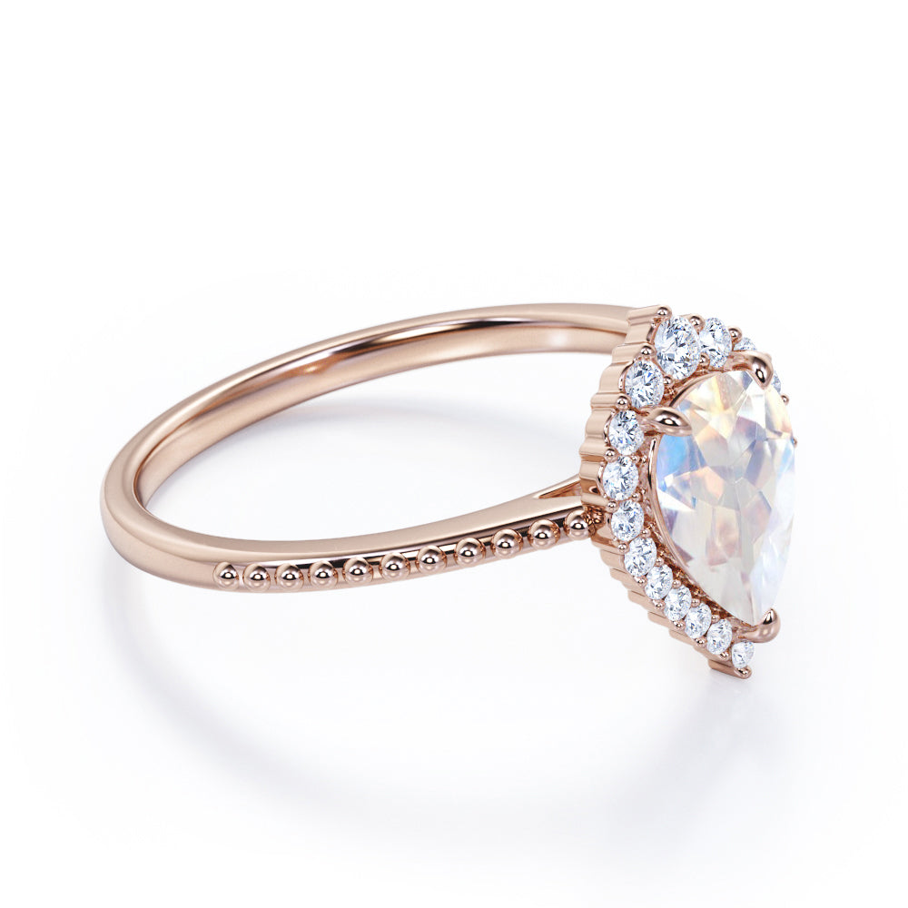 Royal themed 1.3 carat Pear Moonstone and diamond Milgrain and halo engagement ring in White gold