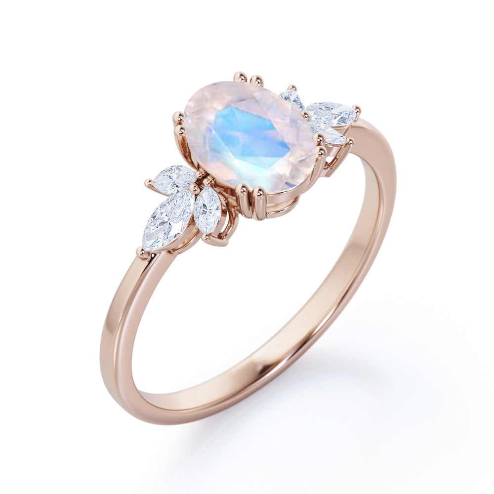 Floral inspired 1.25 carat Oval cut Rainbow Moonstone and marquise diamond double prong engagement ring in Black gold