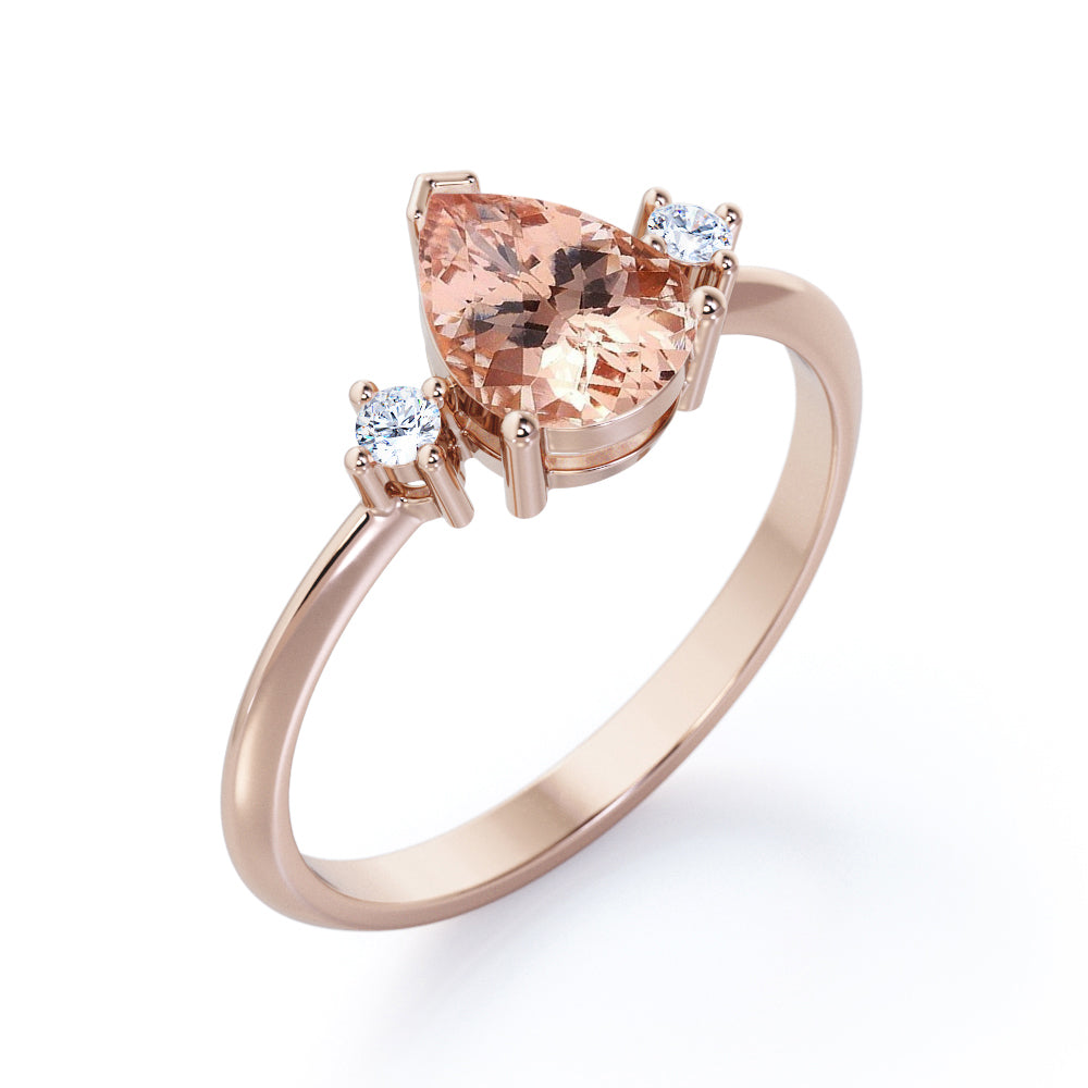 Three prong setting 1.1 carat Pear shaped Morganite and diamond trilogy anniversary ring for women in Black gold