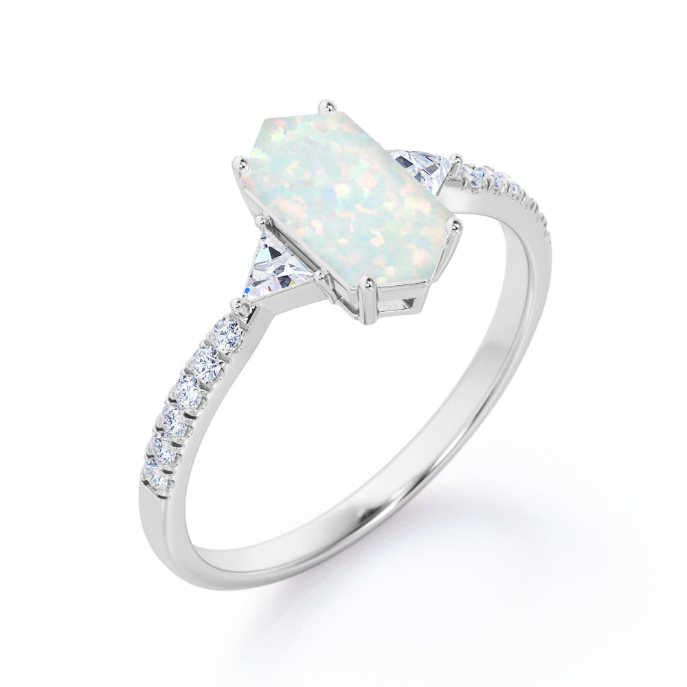 Quadrilateral 3 stone 1.25 carat Hexagon cut Welo Opal and diamond trillion engagement ring in Black gold