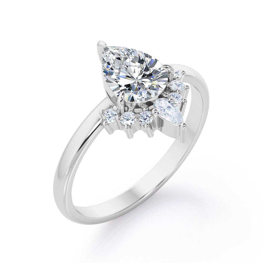 Chevron crown inspired 1.1 carat Pear shaped Moissanite and diamond engagement ring in Rose gold
