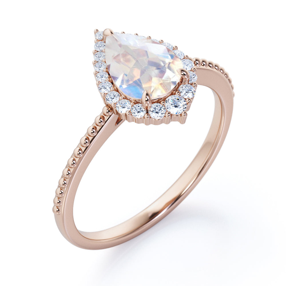Royal themed 1.3 carat Pear Moonstone and diamond Milgrain and halo engagement ring in White gold