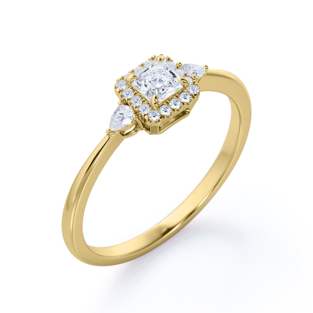 Tapered triple stone 0.7 carat Round cut Moissanite and diamond halo engagement ring in White gold