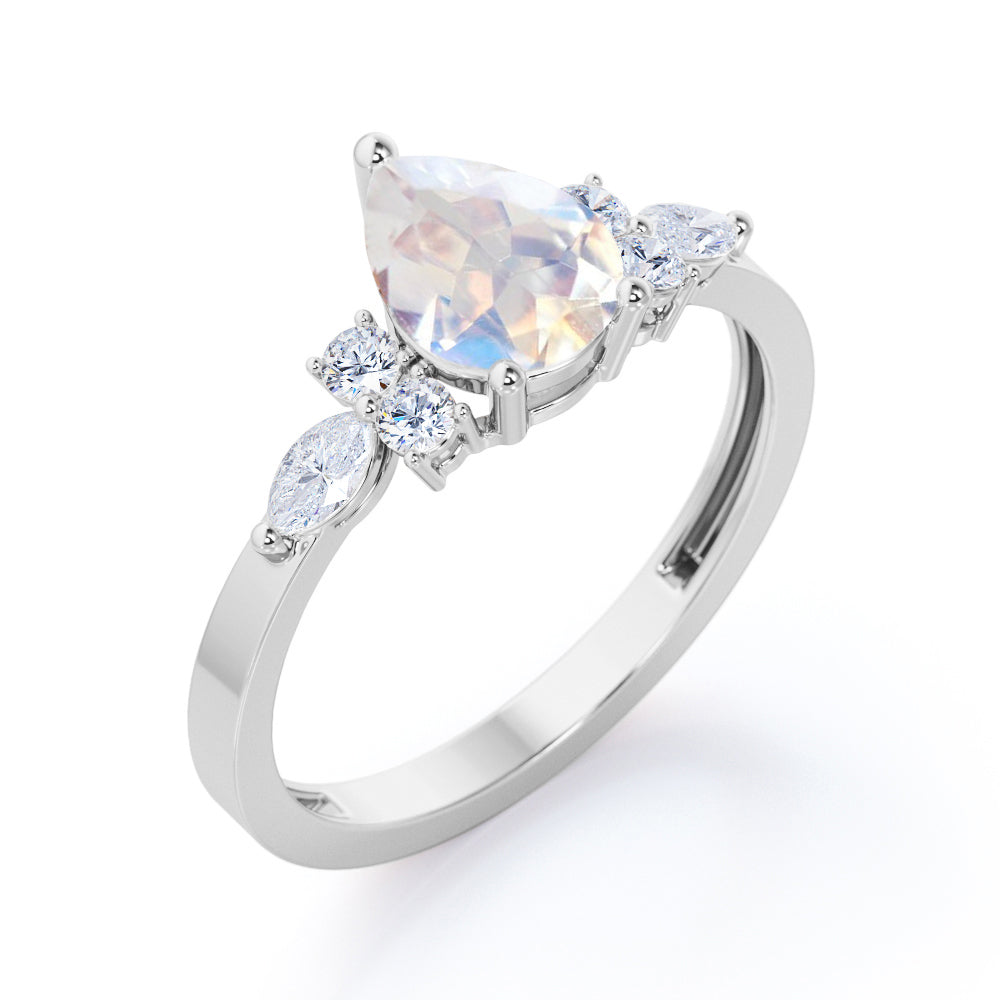 Seven stone 1.25 carat Pear Cut Rainbow Moonstone and diamond triad engagement ring in Black gold