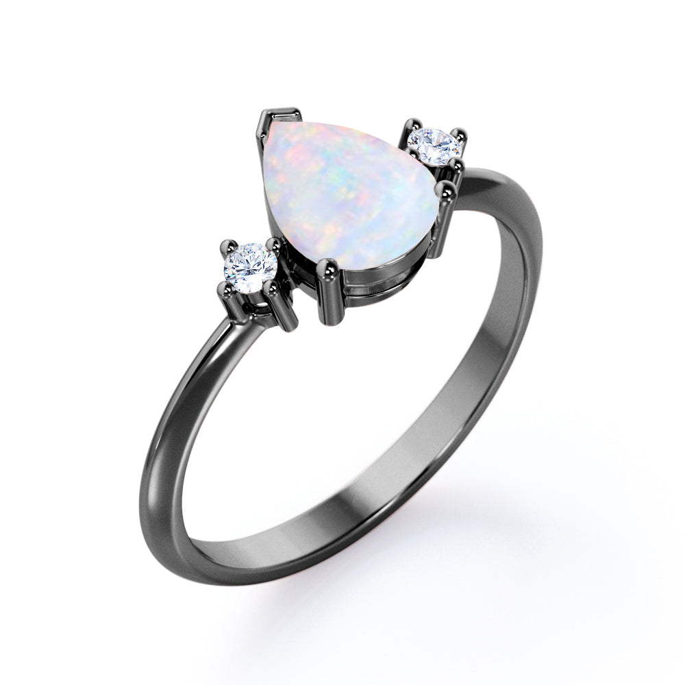 Elegant Three stone 1.10 carat Tear drop shape Ethiopian Opal and diamond pinched shank engagement ring in Black gold