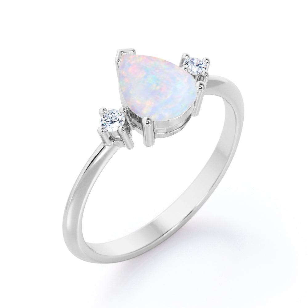 Elegant Three stone 1.10 carat Tear drop shape Ethiopian Opal and diamond pinched shank engagement ring in Black gold