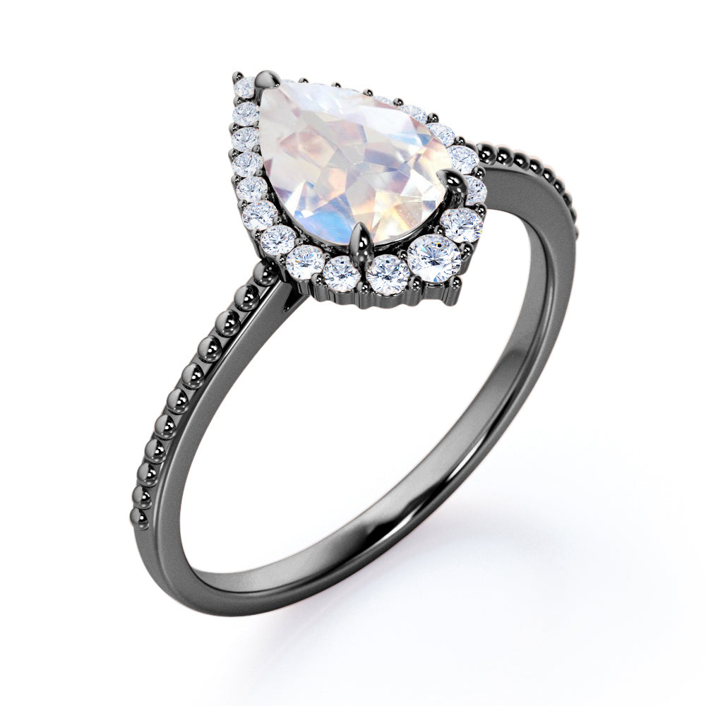 Royal themed 1.3 carat Pear Moonstone and diamond Milgrain and halo engagement ring in White gold