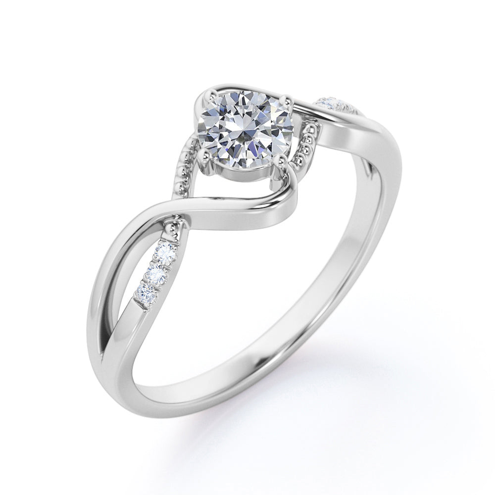 Vintage style twisted 1.25 Round cut Moissanite and diamond infinity engagement ring in Rose gold
