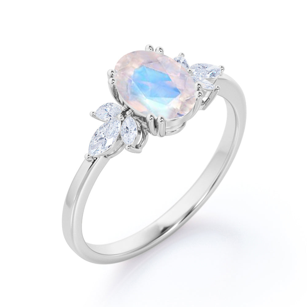 Floral inspired 1.25 carat Oval cut Rainbow Moonstone and marquise diamond double prong engagement ring in Black gold