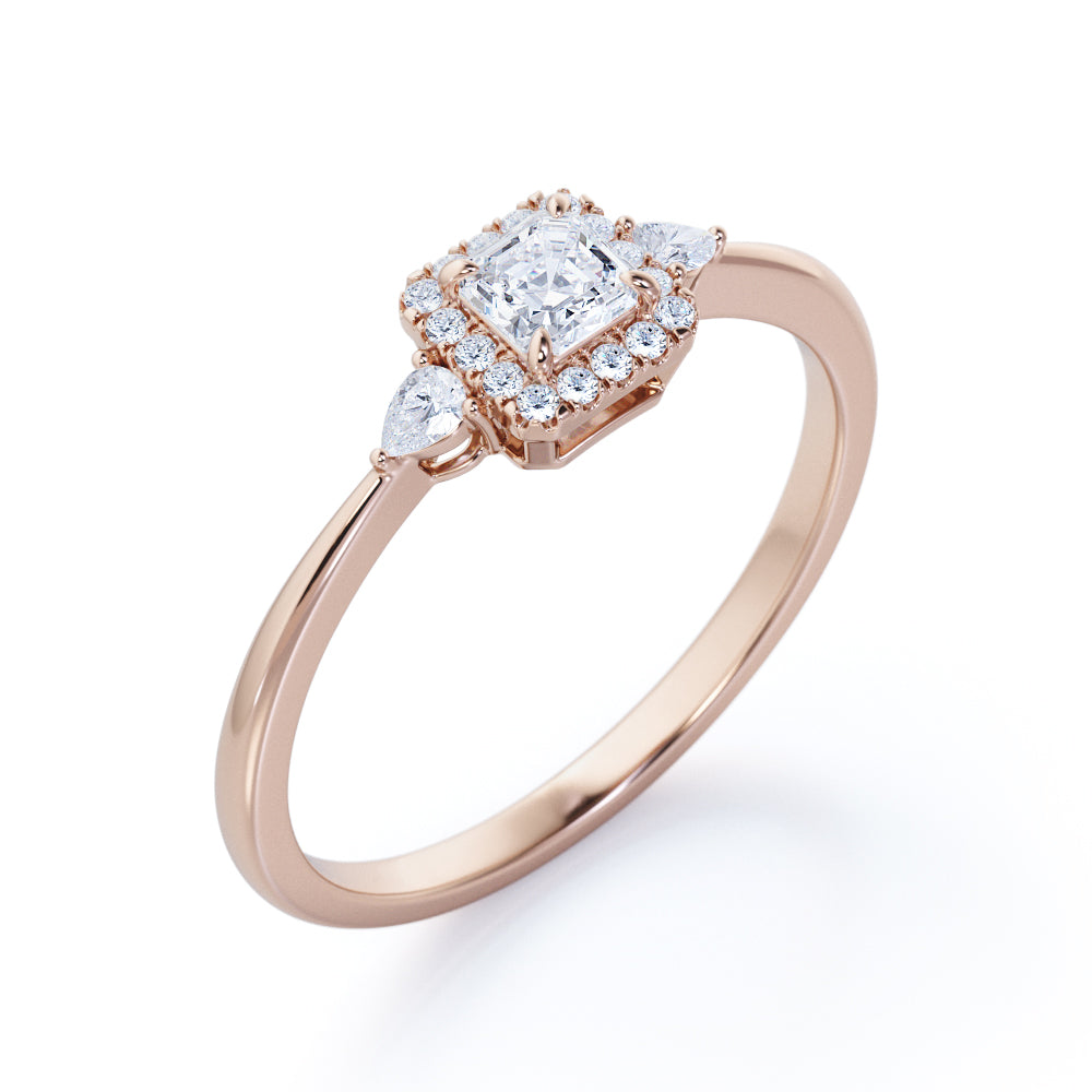 Tapered triple stone 0.7 carat Round cut Moissanite and diamond halo engagement ring in White gold