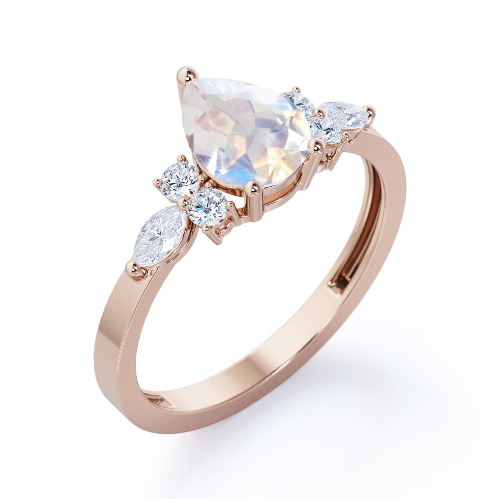 Seven stone 1.25 carat Pear Cut Rainbow Moonstone and diamond triad engagement ring in Black gold