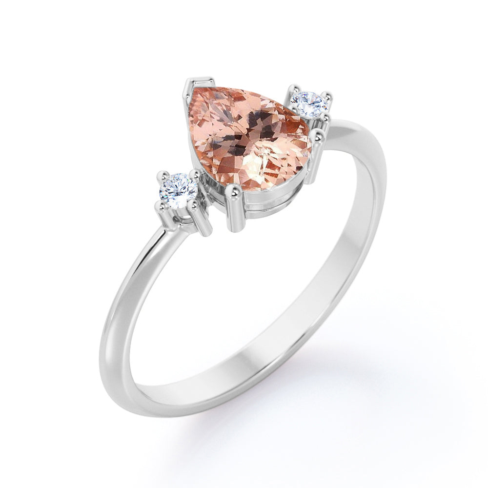 Three prong setting 1.1 carat Pear shaped Morganite and diamond trilogy anniversary ring for women in Black gold
