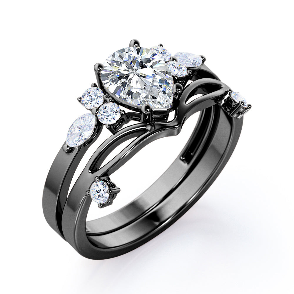 Split shank Chevron 1.2 carat tear drop shaped Moissanite and diamond art deco style engagement ring in Black gold