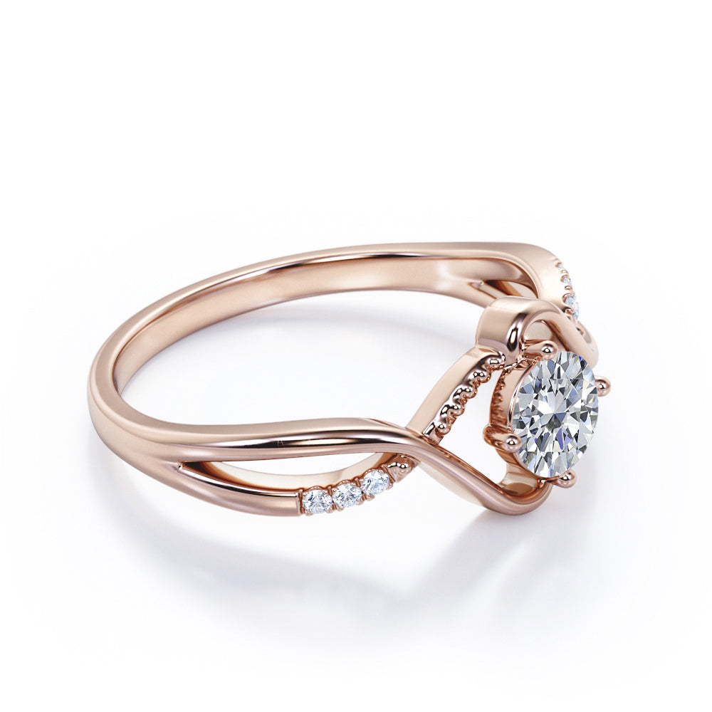 Vintage style twisted 1.25 Round cut Moissanite and diamond infinity engagement ring in Rose gold