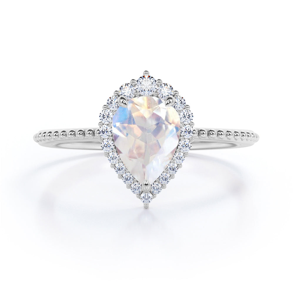 Royal themed 1.3 carat Pear Moonstone and diamond Milgrain and halo engagement ring in White gold