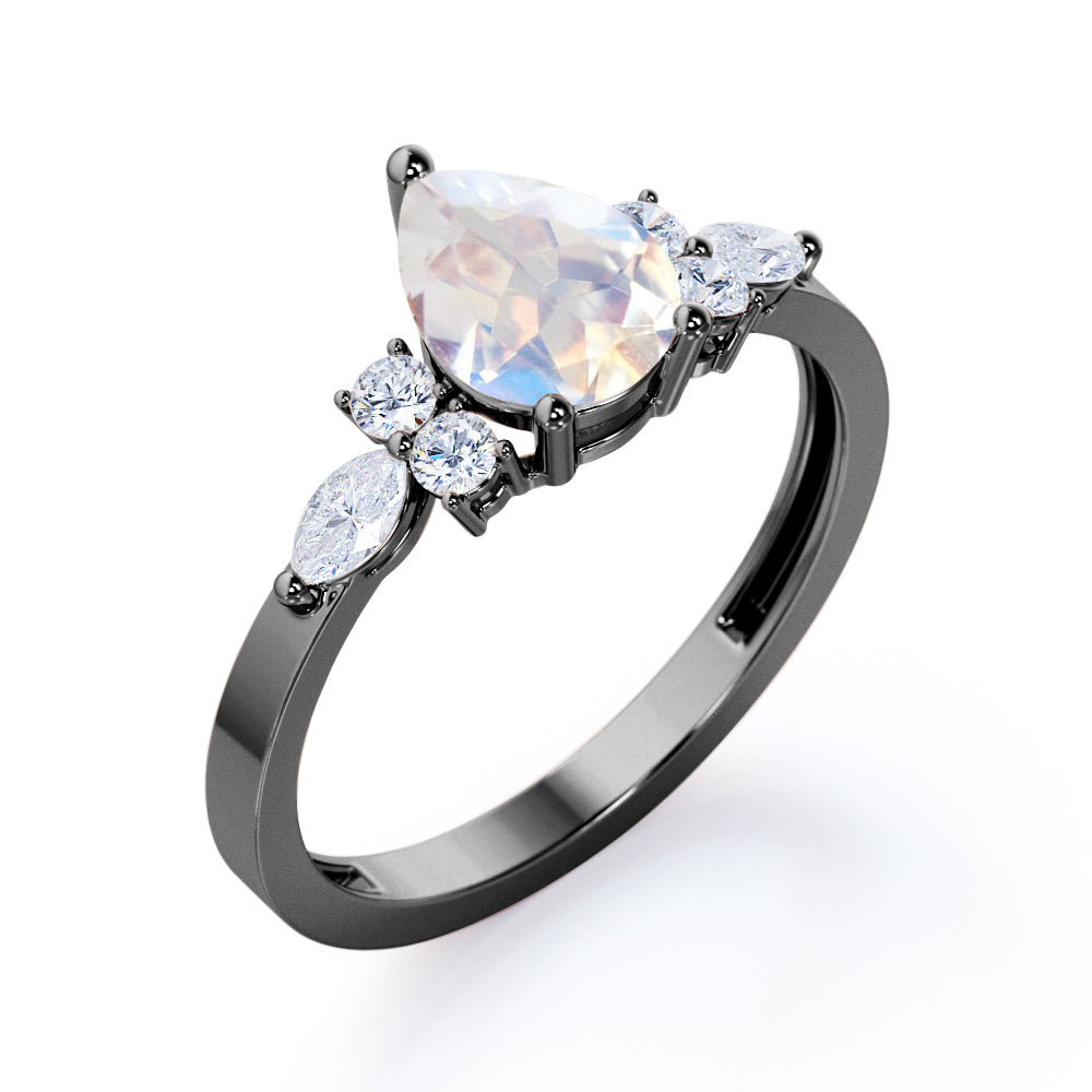 Seven stone 1.25 carat Pear Cut Rainbow Moonstone and diamond triad engagement ring in Black gold