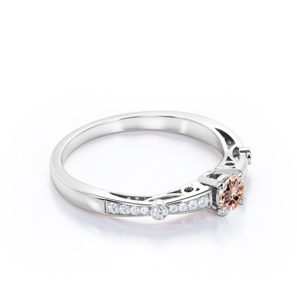 Prong style 0.75 carat Round cut Peach Pink Morganite and diamond tapered baguette engagement ring in White gold