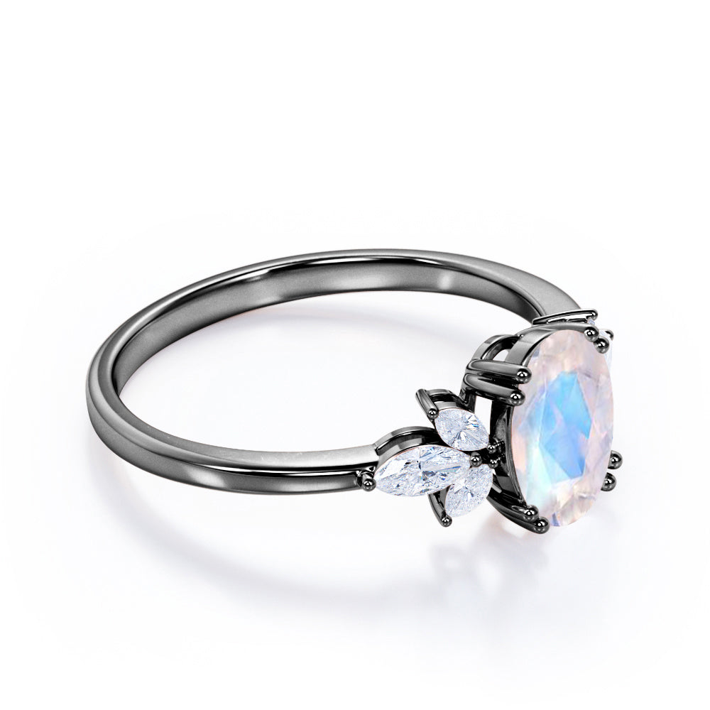 Floral inspired 1.25 carat Oval cut Rainbow Moonstone and marquise diamond double prong engagement ring in Black gold