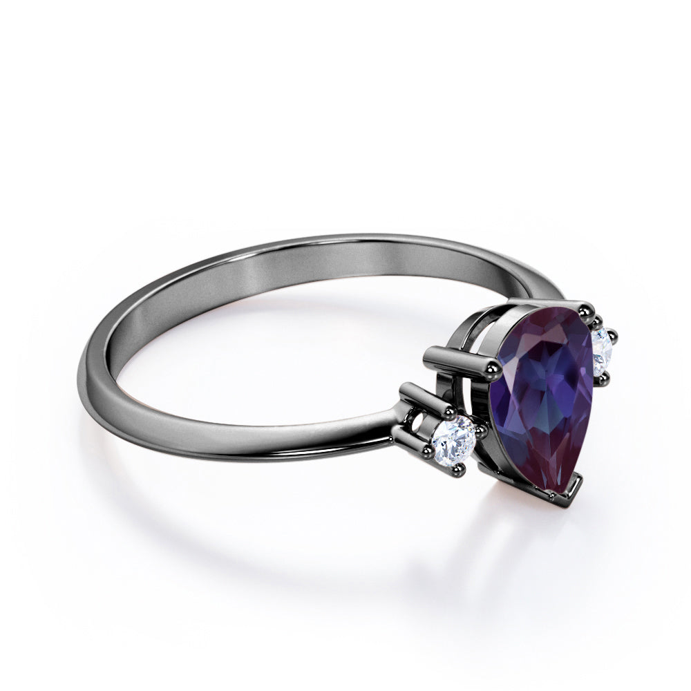 Classic three stone 1.1 carat Pear shaped Alexandrite and diamond pinched shank engagement ring for women in Black gold